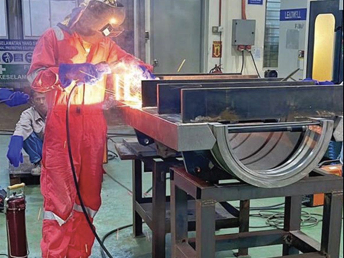 Welder joining a fabricated steel assembly